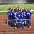 The boys soccer team celebrates their victory after the game.