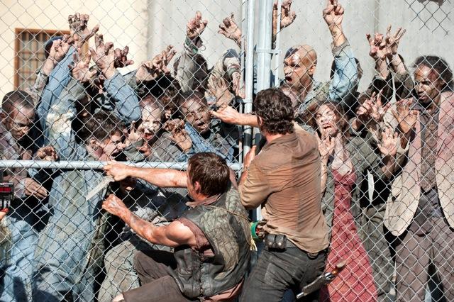 Characters Daryl and Rick fight off walkers during the season three premiere episode.