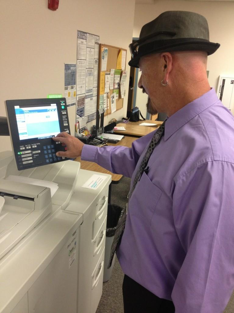 David Rhine works the copy machine in the office.