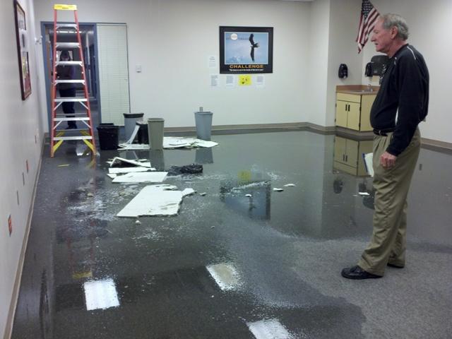 Mike Cornish, athletic director who is in charge of facilities, stands in the aftermath of the flood in the sweep room.