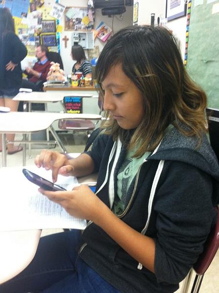 Jenee Campa, junior, uses a phone. Many students use their phone during the school day to check their grades on PowerSchool.