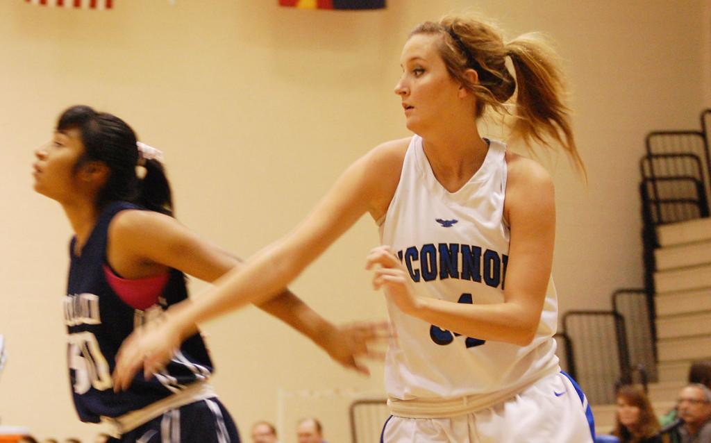 Paige Bonnette, senior, jumps in front of an opponent in order to try and get a rebound. 