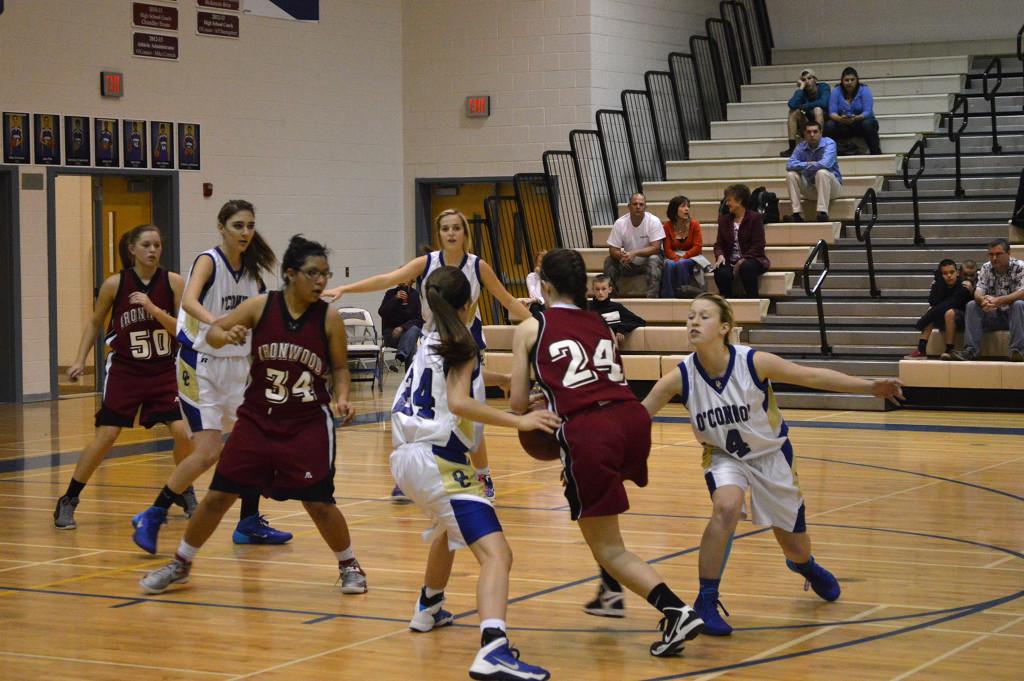 The JV girls pull together on defense to stop the opposing team from making a shot. 