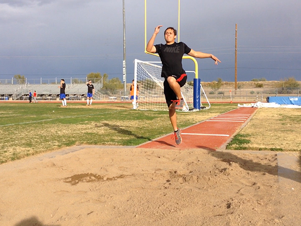 Lonnie Kamacho, junior, practices his form for the long jump.