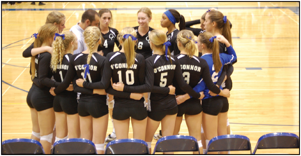 Varsity coach Kyle Brainard gives the team an encouraging pep talk before they get back on the court to play