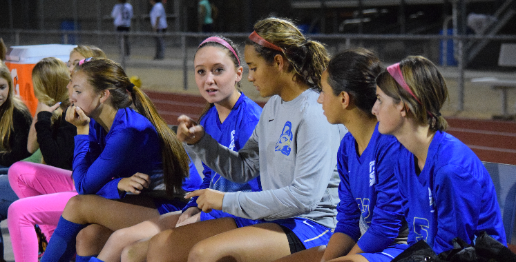 The benched girls wait for their play during the game against Maryvale