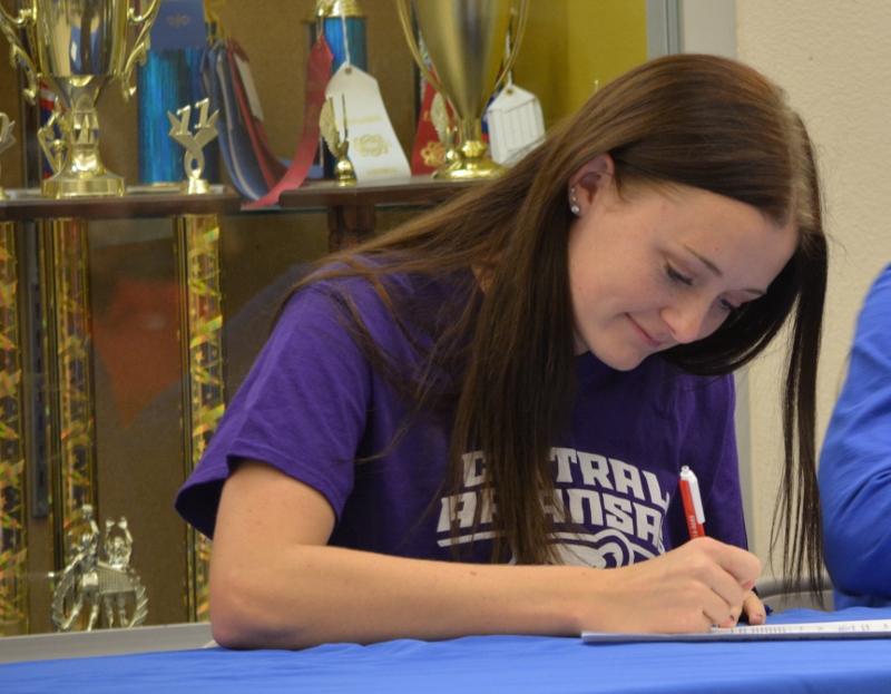 Savannah Tidd, senior, joins several other students in signing with their future college.