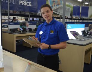 Nathan Winkle, junior, selling computers at his job at best buy.