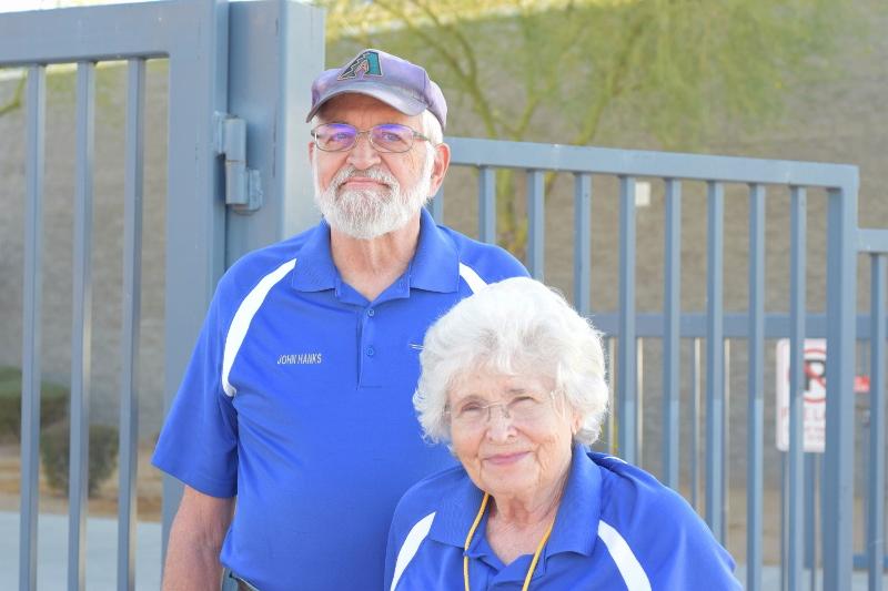 John and Wilma Hanks pose for a picture as they greet students coming in from the student parking lot.