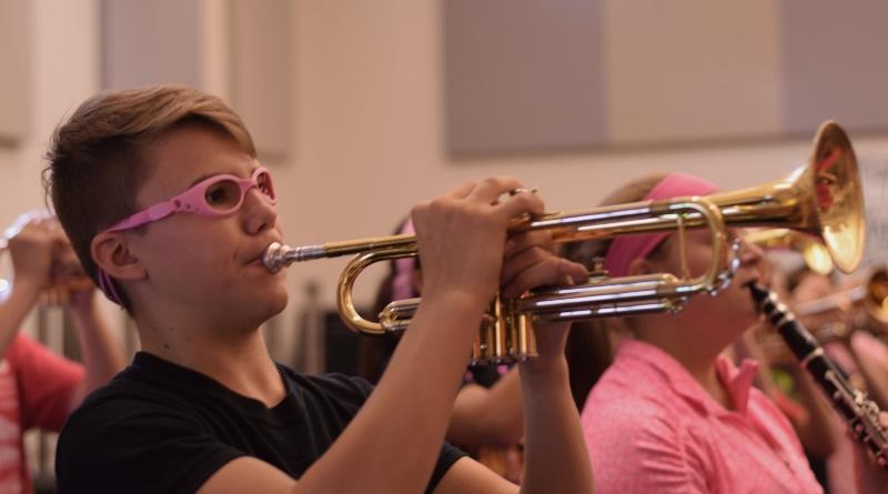 Sylvan Austin, freshman, plays the trumpet at marching band practice in preparation for a game.