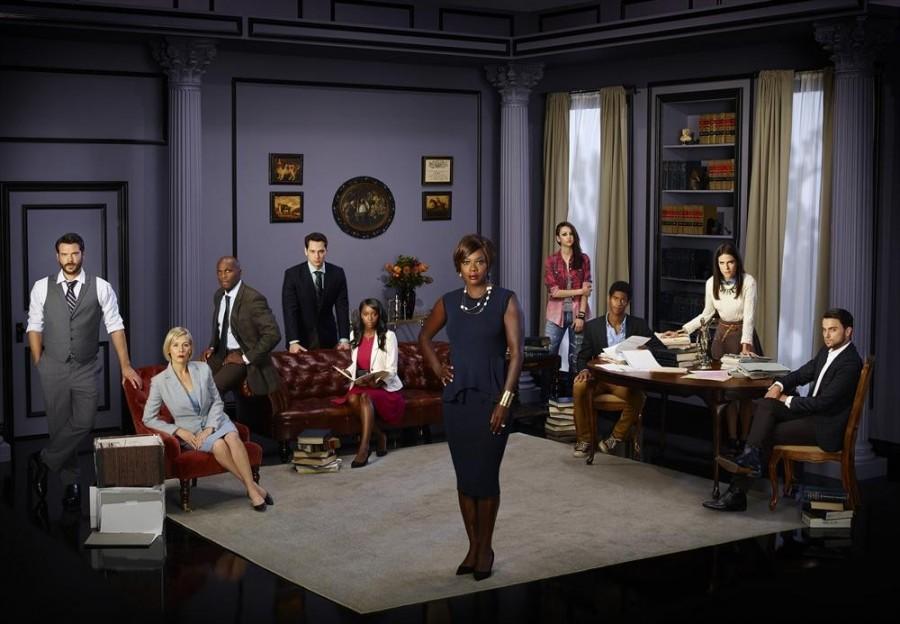 PHOTO COURTESY OF ABCALLACCESS 
The cast of How to Get Away With Murder standing around on the set of Annalise Keatings office.  