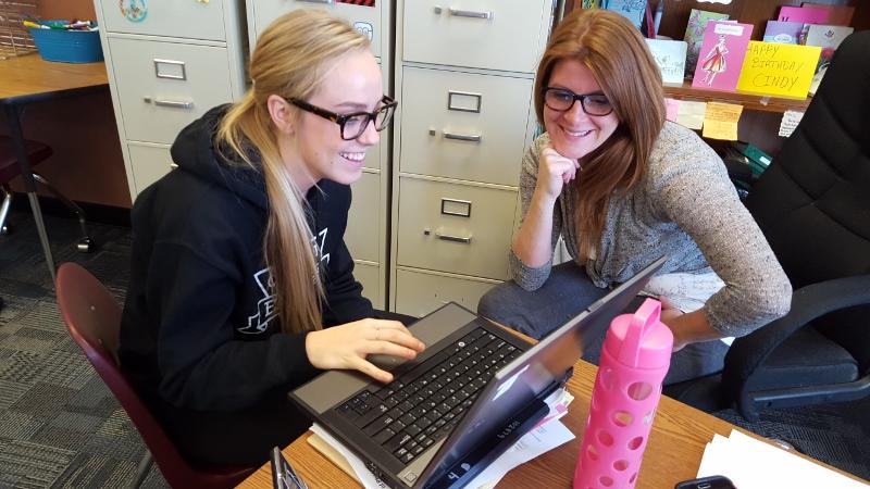 Cindy Garraway assists Destiny Siegrest,sophomore, with her end of the year speech in the dual enrollment communications class. If the override had not been passed this class and others like it would most likely have lost its funding. 