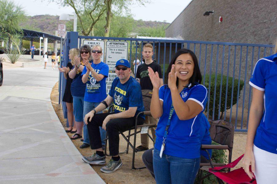 The OHS counseling staff including (from right to left) Tiffany Ostrowski, Chris Harmonson and Katie Loucks cheer on the students going by in the parade. 