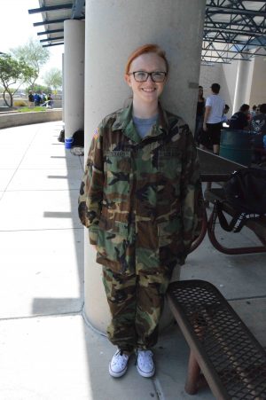 Jazmyn Hazen, senior, shows off her family member’s uniform to inform people who her hero is.