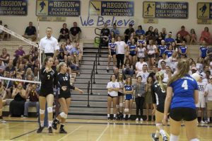 Sami Hover, senior, and Kelly Agnew, junior, bumps and sets the ball towards their opponent.