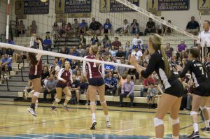 Kelly Agnew, junior, prepares to block the ball from their opponent.