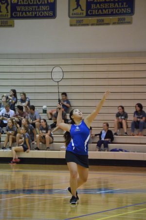 Lillian Ha, senior, gets her racket and position ready to smash the birdie to her opponent leaving her with a point. 