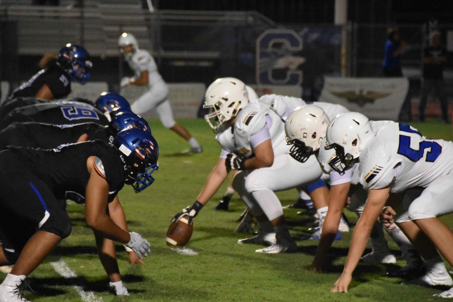 Ben Fuenmayor, sophomore, prepares to snap the ball in the game against Chandler.