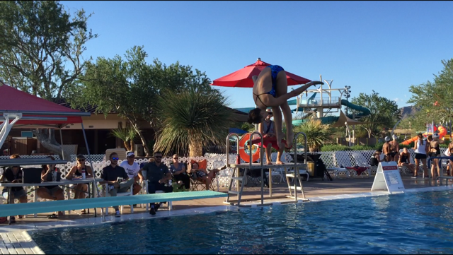 Diver Addison Krupp wows the judges with an inward dive. On September 8, the OHS swim and dive team conquered their first meet. 