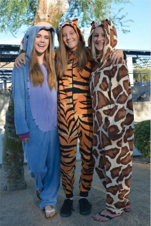 Freshmen Cortney Hansen, Ariana Rogers, and Aimee Kabello coordinate in their matching animal onesies for Thursday’s spirit day.