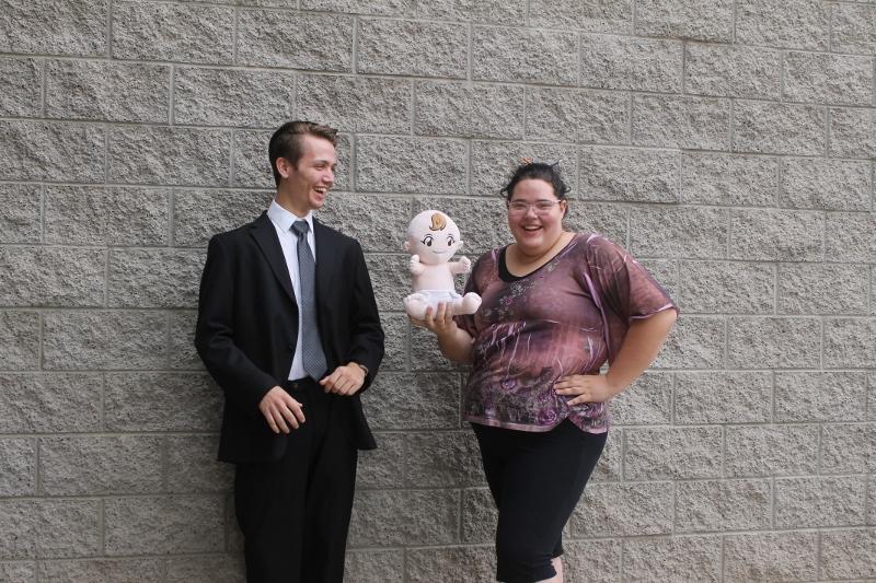 From left to right, Kieran Younger, senior, and Nicole Roush, senior, share a laugh in their contrasting spirit day outfits. 