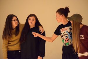 (Left to right) Eva Yont, Junior, Lauren Coe, junior, One Griffin, junior, and Mandy Moisoff, junior, play two-headed man, where each pair has a conversation with the other pair while trying to form coherent sentences with their partners.