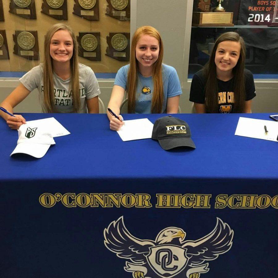 (From left to right) Paige Donathan, Ally Eller and Maddie Soles sign a contract to go to a specific college. 