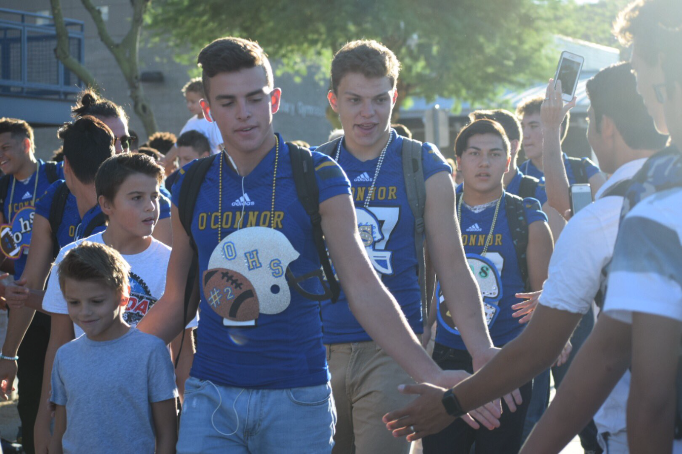 Football players enter the crowd during the first Eagle Walk preparing for their game against Mountain Pointe.