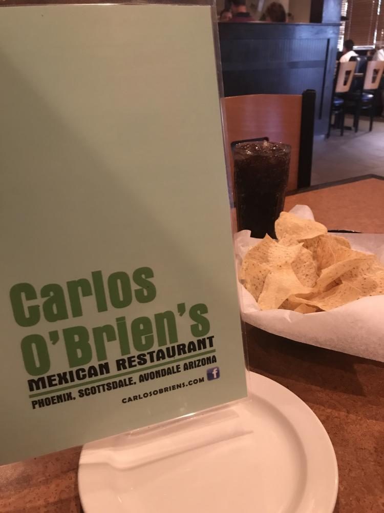 A menu, chips, and Dr. Pepper sit on a table at Carlos O'Brien's as customers decide what to order. 