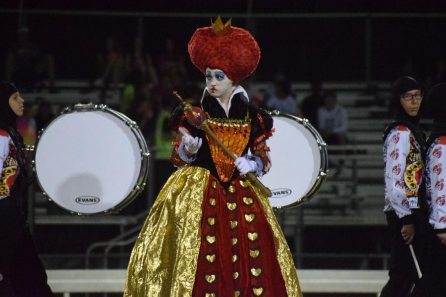 Mackenzie Fugatt, senior, stands in her Red Queen costume during half time. 