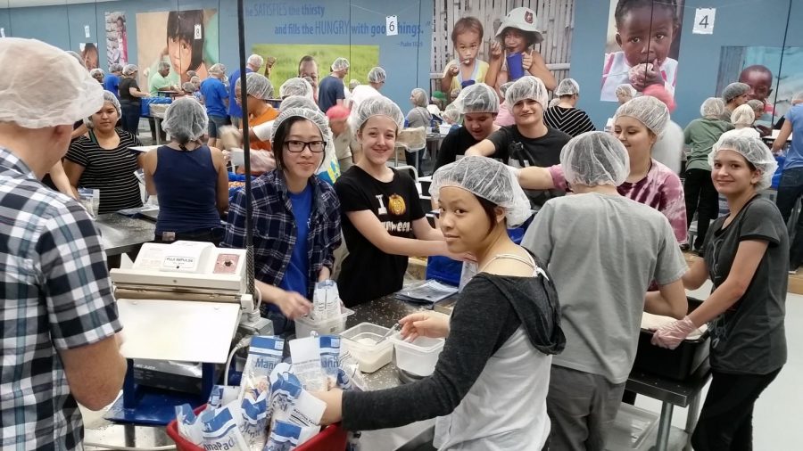 Melissa Mara takes her students out to St. Marys Food Bank to help out with families.