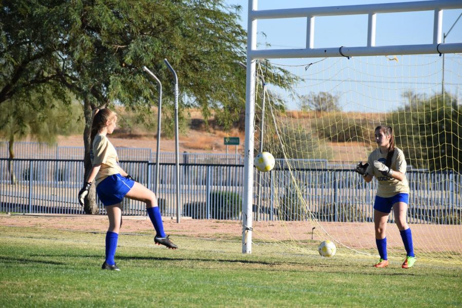 JV and Varsity soccer practice together to improve their skills, such as goalkeeping and scoring.