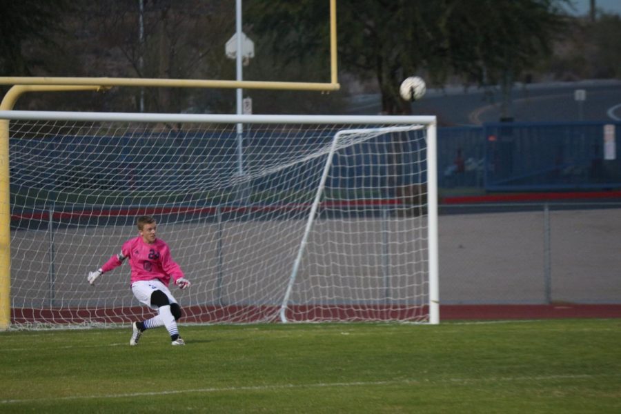 Chase Toncheff, junior, kicks the ball back into the action.