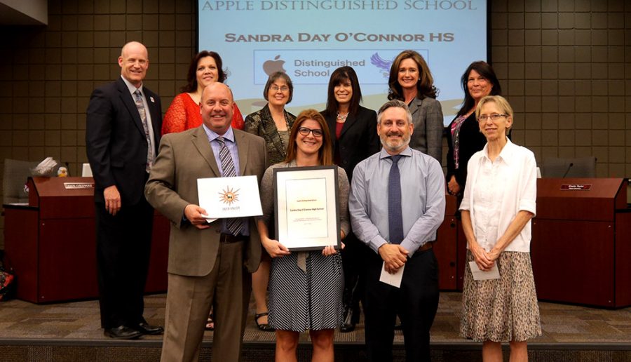 Some of the staff of OHS and the district office strike a pose as they show off their newly-won Apple tech award.