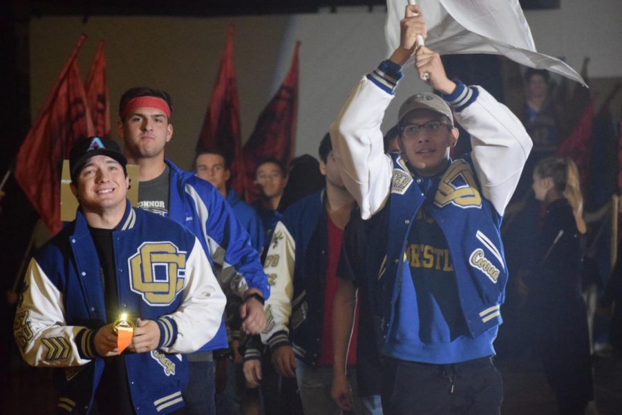 Wrestling waves their flag through the opening ceremony of the Olympic OC Assembly