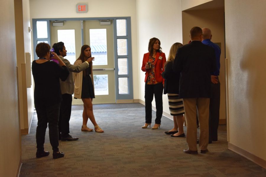 A+ evaluators take a tour of the classrooms at the school to interview students. 