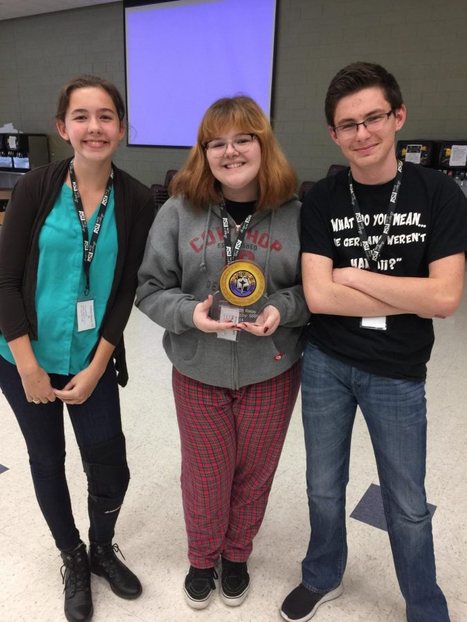 Ashlen Sperry, Alayna Dinges, and John Wolpert bask in the applause at District Academic Decathlon Competition at Boulder Creek High School on Nov. 4, 2017. The team won the Super Quiz Relay and were awarded the traveling trophy.