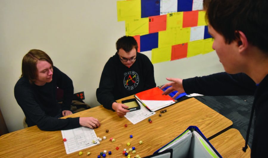 Juniors. Aidan Arredondo, Zephaniah Bliss, and Karson Knudson roll dice in D&D.