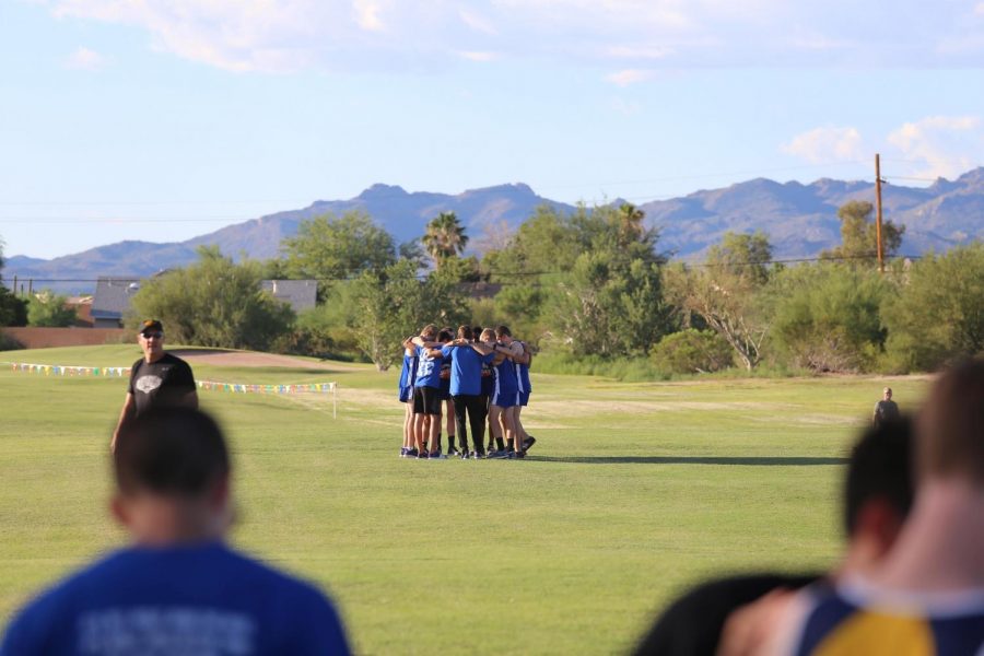 Cross+country+boys+huddle+together+before+the+first+race+of+the+season