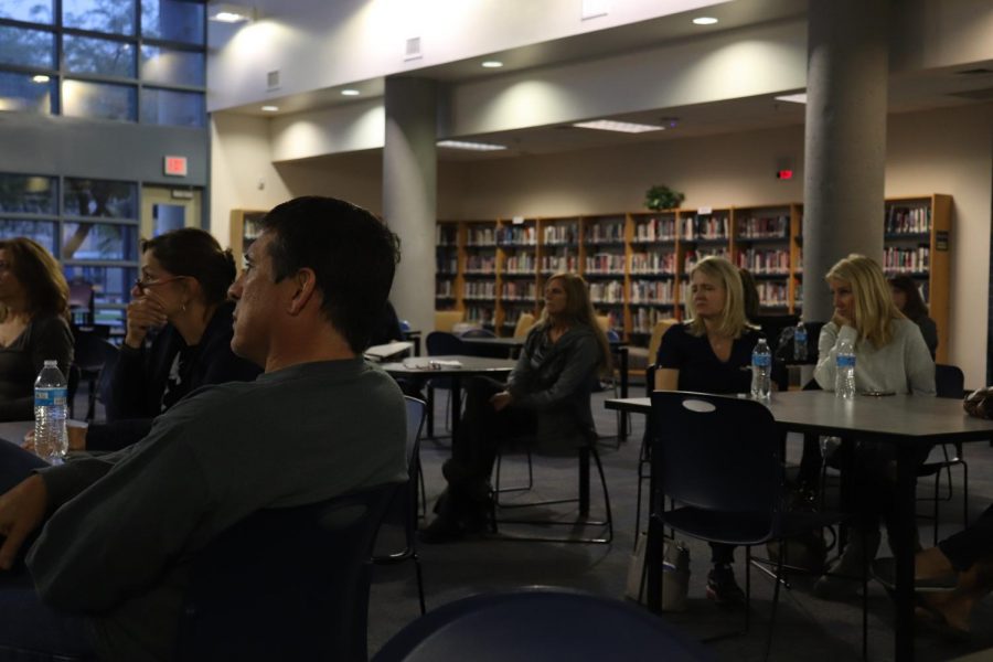 The parents in attendance of the OHS Drug Abuse and Mental Health Awareness Night watch a newscast about vape. 