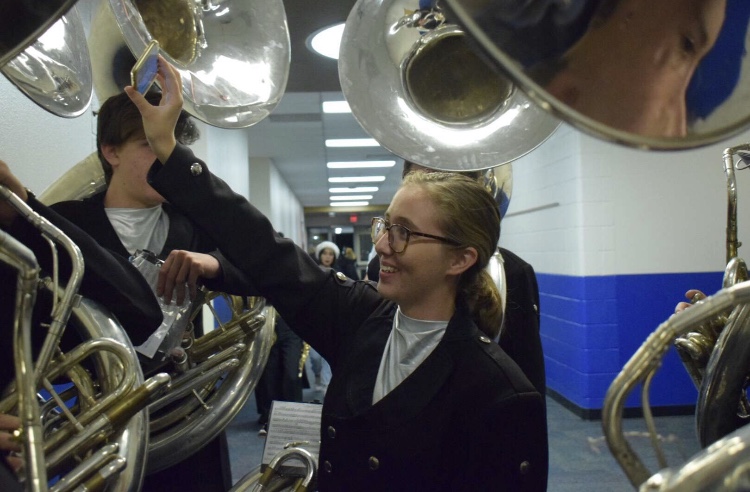 Braedyn Pentowski, sophomore, helps prepare others to perform a wonderful a wonderful winter concert.