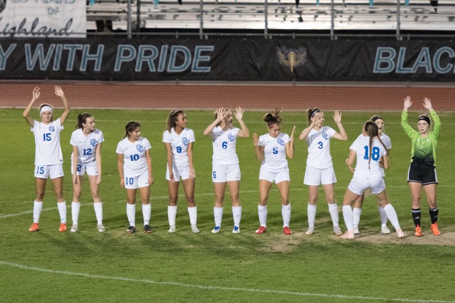 Varsity girls soccer prepares for their game by announcing their starting lineup for the night ahead.