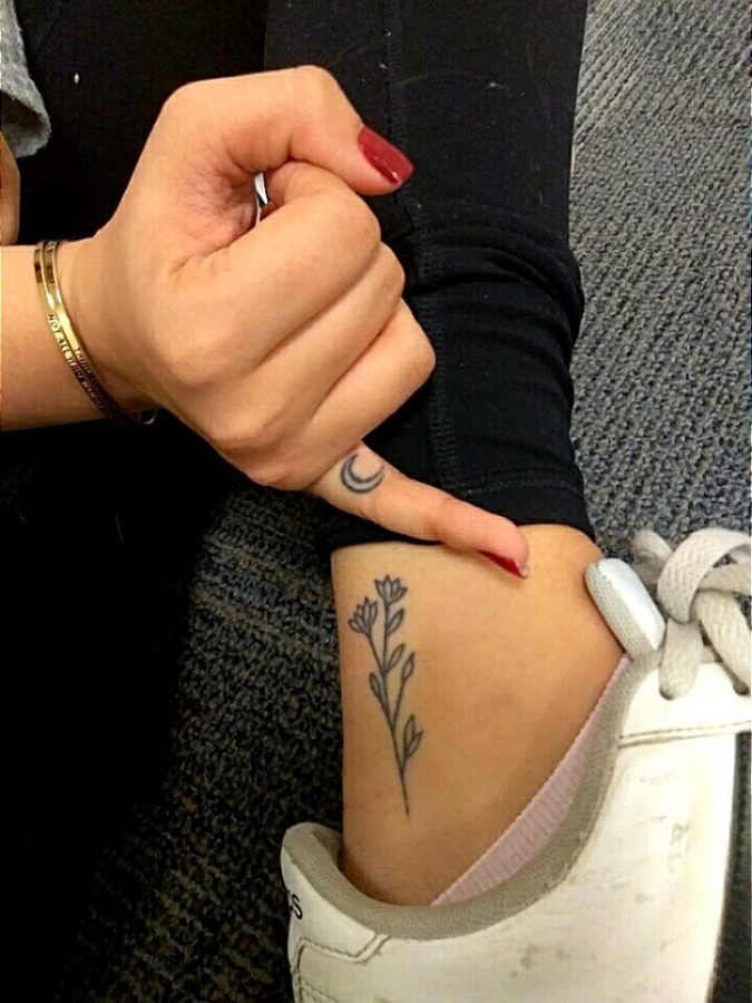 Cassidy Meyer displays her simple ink designs on her finger and ankle.