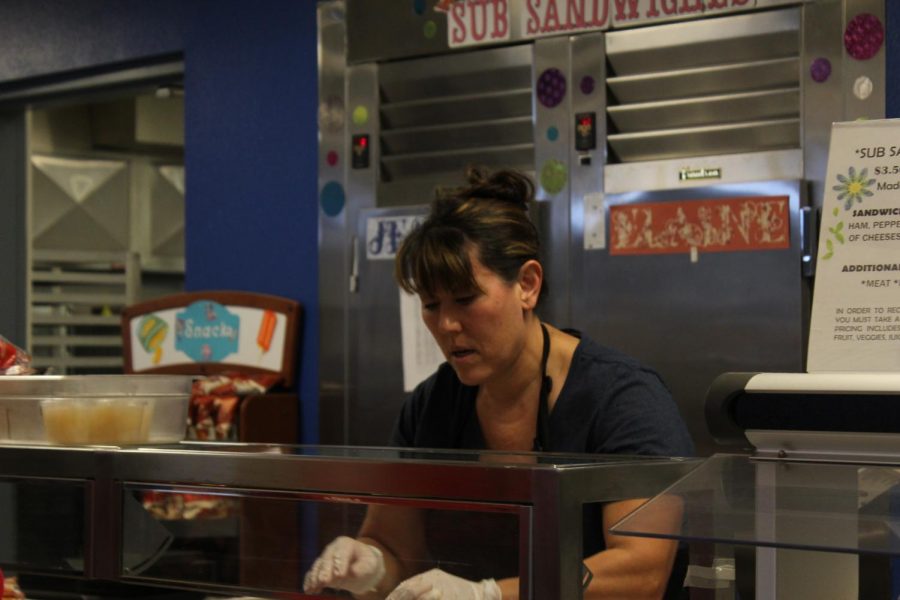 Renna Griffin works hard in the cafeteria to serve hungry students at lunch time.