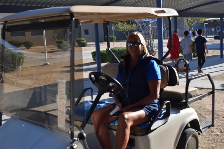 Darcy Wine, security staff, poses for a photo on one of the golf carts used to patrol the campus. 