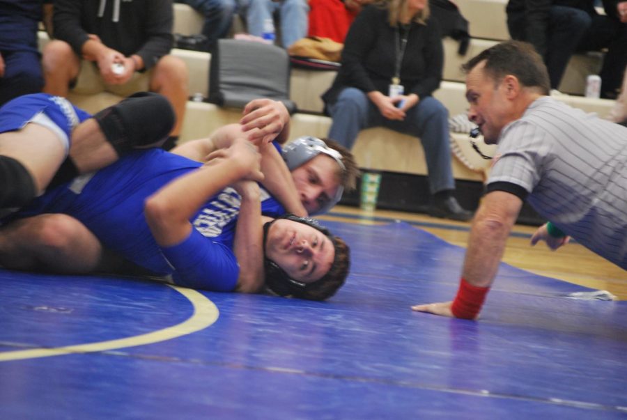 Matthew Andonov, senior, duels it out with wrestler from Westview.