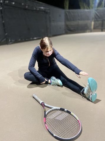 Emily Smitten, freshman, stretches after playing tennis.