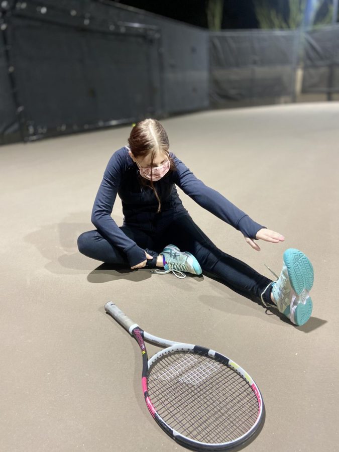Emily Smitten, freshman, stretches after playing tennis.