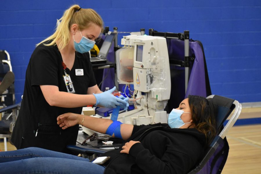 Aniya King, senior, donates blood at the blood drive.