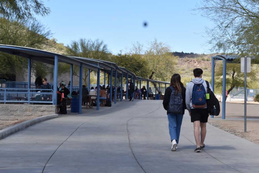 Hailey Bishop, junior, and Kainoa Gesino, senior, walk through campus during their lunch hour.